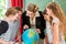 Teacher educate students having geography lessons in school
