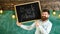 Teacher in eyeglasses holds blackboard with title back to school. Hiring teachers concept. Man with beard and mustache