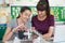 Teacher With Female Pupil Studying Robotics In Science Lesson