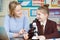 Teacher With Female Student Using Microscope In Science Class