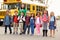 Teacher and a group of elementary school kids at a bus stop