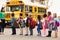 Teacher and a group of elementary school kids at a bus stop