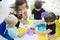 Teacher guiding her pupils to make stickers