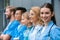 teacher and happy multicultural students standing in row