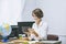 Teacher happy young woman in a classroom with electronic tablet