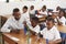 Teacher helping elementary school kids counting with blocks