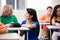 Teacher Helping Female High School Student In Classroom