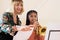 Teacher Helping Female Student To Play Trumpet In Music Lesson