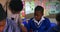 Teacher helping schoolchildren in a lesson at a township school 4k