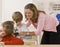 Teacher helping student with microscope