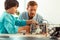 Teacher and his pupil polishing up a robot.