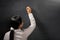 Teacher holding chalk on blank blackboard