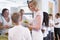 Teacher holding plate of lunch in school cafeteria