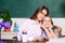 Teacher kind lady with pupil. Doing homework with mom. Little girl and woman sit at desk. School education. Studying