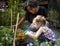 Teacher and little girl school learning ecology gardening