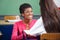 Teacher Looking At Teenage Schoolgirl At Desk