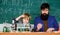 Teacher man with little boy. school lab equipment. Back to school. father and son at school. using microscope in lab