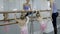 Teacher near ballet shows young children dance position.