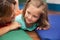 Teacher playing on the floor with a litlle girl