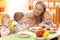 Teacher and preschooler kids having break for fruits