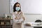 Teacher with protective mask in classroom. Reopening after Covid-19 quarantine