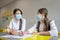 Teacher in protective mask talking to her pupil