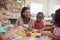 Teacher And Pupils Using Flower Shapes In Montessori School