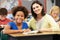 Teacher Reading With Female Pupil In Class