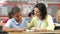 Teacher Reading With Male Pupil In Class