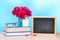 Teacher`s day holiday greeting icon. Education knowledge day concept. Wooden chalk board frame and vase bouquet on table empty cop