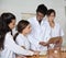 Teacher Showing Digital Tablet To Female Students