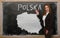 Teacher showing map of poland on blackboard