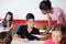 Teacher Showing Paper To Teenage Schoolboy During