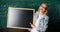 Teacher smart smiling woman hold blackboard blank advertisement copy space. Remember this information. School schedule