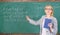 Teacher smart woman with book explain topic near chalkboard. School teacher explain things well and make subject