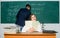 Teacher and student near chalkboard. College university education. STEM faculty. Man writing on chalkboard math formulas