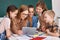 Teacher and students watching video together at school