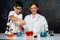 Teacher support schoolboy mixing solution in laboratory STEM class. Erudition.