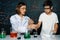 Teacher support schoolboy mixing solution in laboratory STEM class. Erudition.