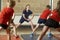 Teacher Taking Exercise Class In School Gym