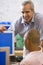 A teacher talks to a schoolboy using a computer