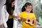 Teacher teach ukulele to girl with Down`s syndrome.