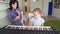 Teacher teaches girl play synthesizer, plays flute