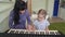 Teacher teaches little girl play on synthesizer