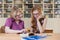 Teacher teaches a student at a table in the classroom