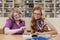 Teacher teaches a student at a table in the classroom