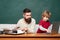 Teacher teaches a student to use a microscope. Happy family - daddy and son together. Man teaches child. Homeschooling