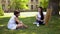 Teacher with two students studdying outdoors.