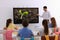 Teacher using interactive board in classroom during lesson