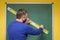 Teacher using a ruler to draw on a chalkboard